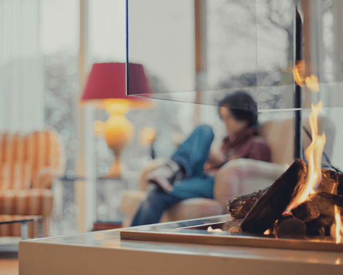 woman relaxing by window at home due to more comfort with Ecolux window film