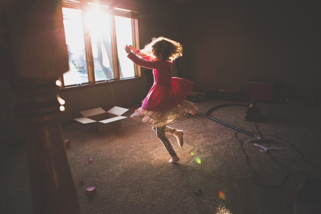 little girl dancing in sunlight