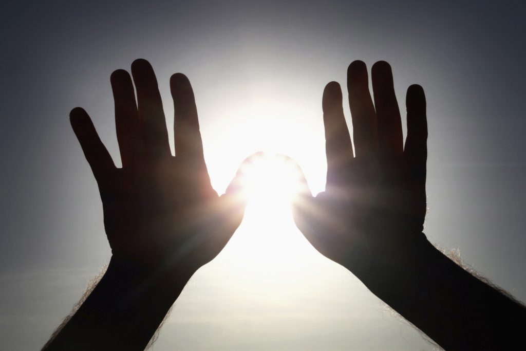 shielding the sun with hands