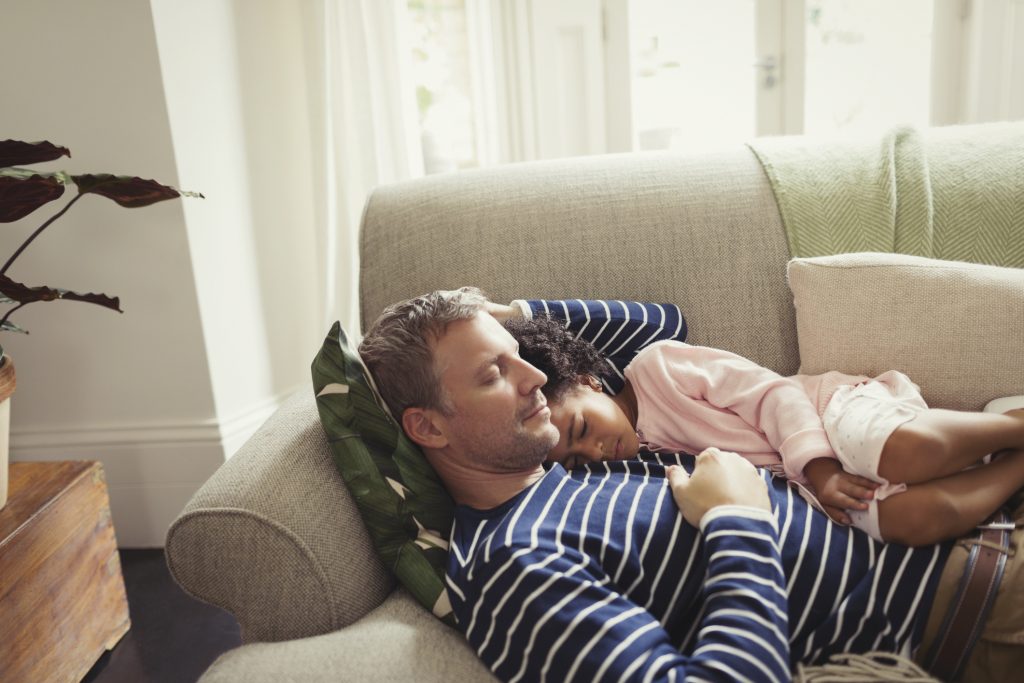 dad and daughter napping on couch