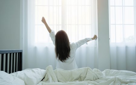 Lifestyle woman at home concept. Lifestyle woman at home concept. back view, Portrait of beautiful Asian woman stretching her body and her arms after she wake up feel sleepy in her bedroom at home.