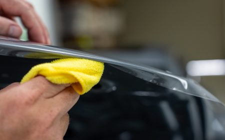 Paint protection film installer tucking film to avoid visible lines.
